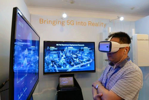 嘉賓在峰會現(xiàn)場利用VR設(shè)備觀看5G測試外場。